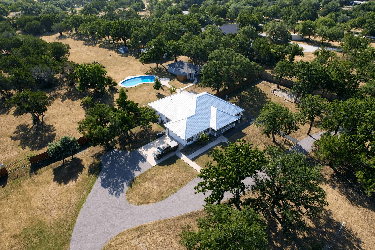 Aerial view of a tree-filled property on Young Ranch Road